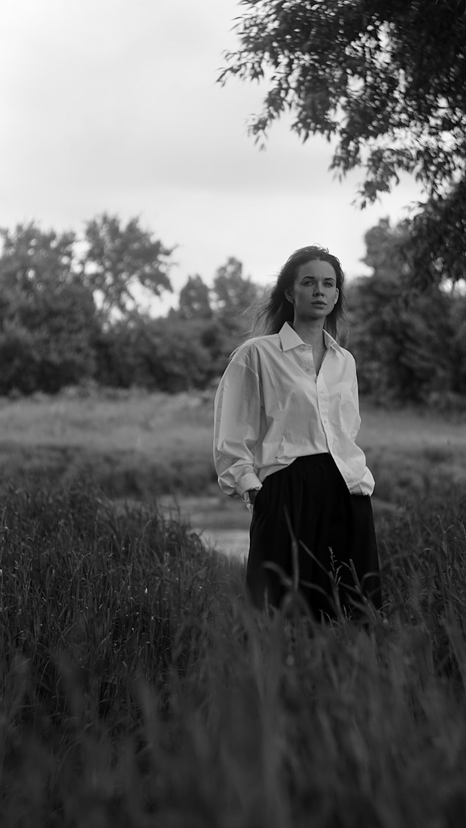 A woman standing in a field of tall grass